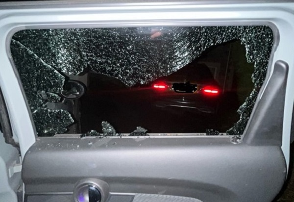 The smashed window of one of the damaged cars