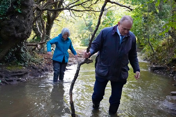 Claire Young and Sir Ed Davey in the River Frome at Frampton Cotterell